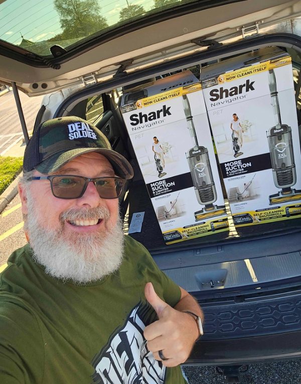 John Gray, Deal Soldier member from Alabama, with two Shark vacuums from a Target clearance find